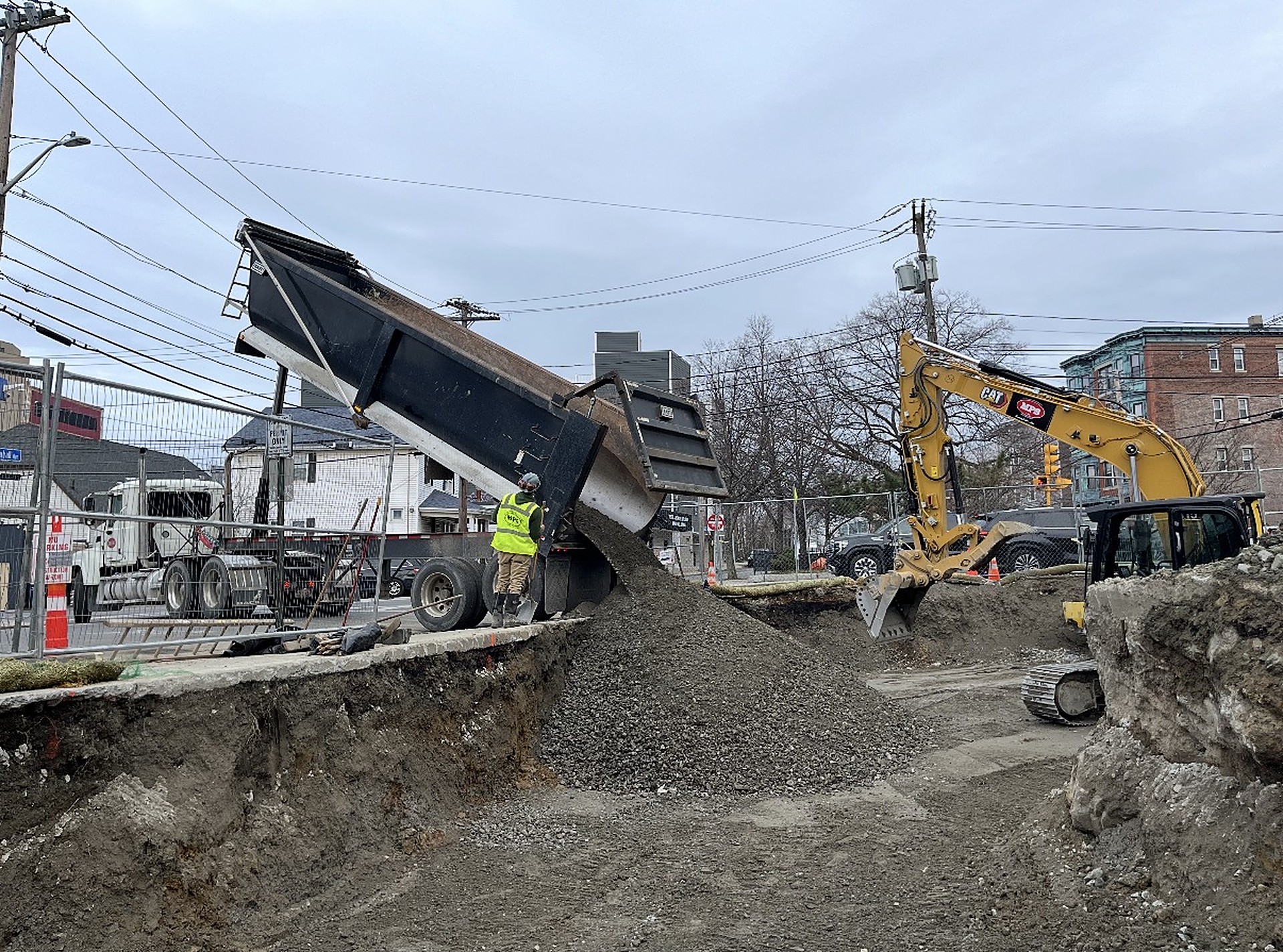 Mass Pipeline Services excavator and dump truck placing stone during excavation and sitework