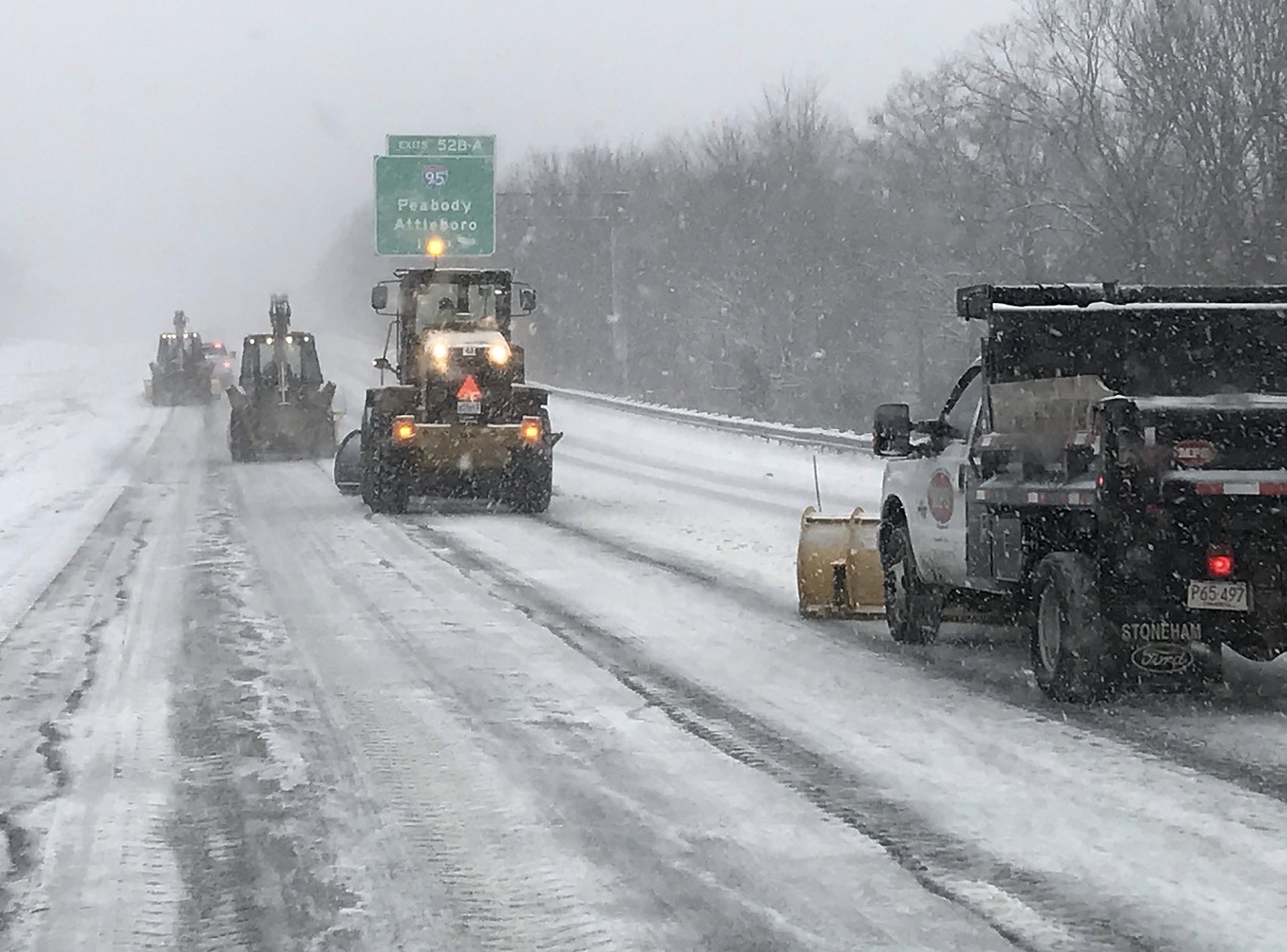 Mass Pipeline Services snow plow truck and loaders clearing snow from a highway during a snowstorm